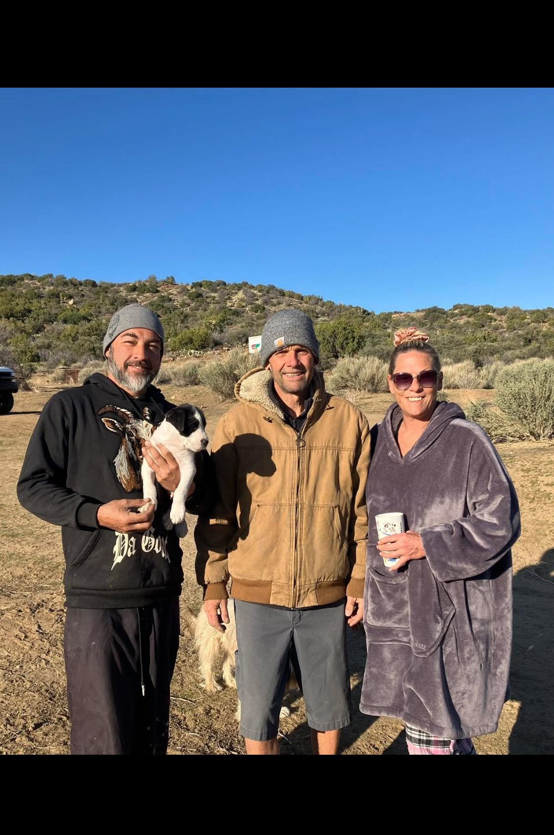 The DeBenedetti family welcoming hikers with a puppy